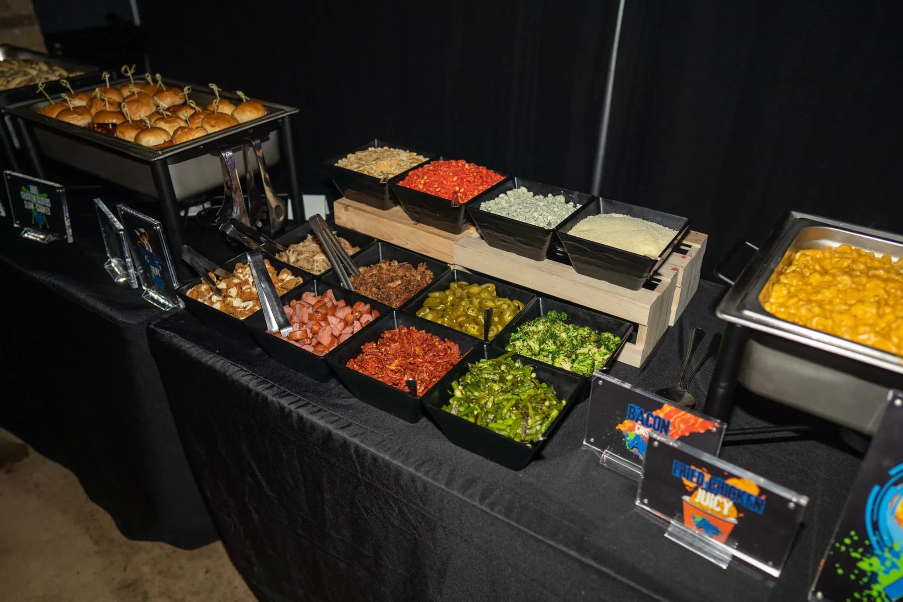 A catering buffet with chafing dishes and build-your-own toppings.