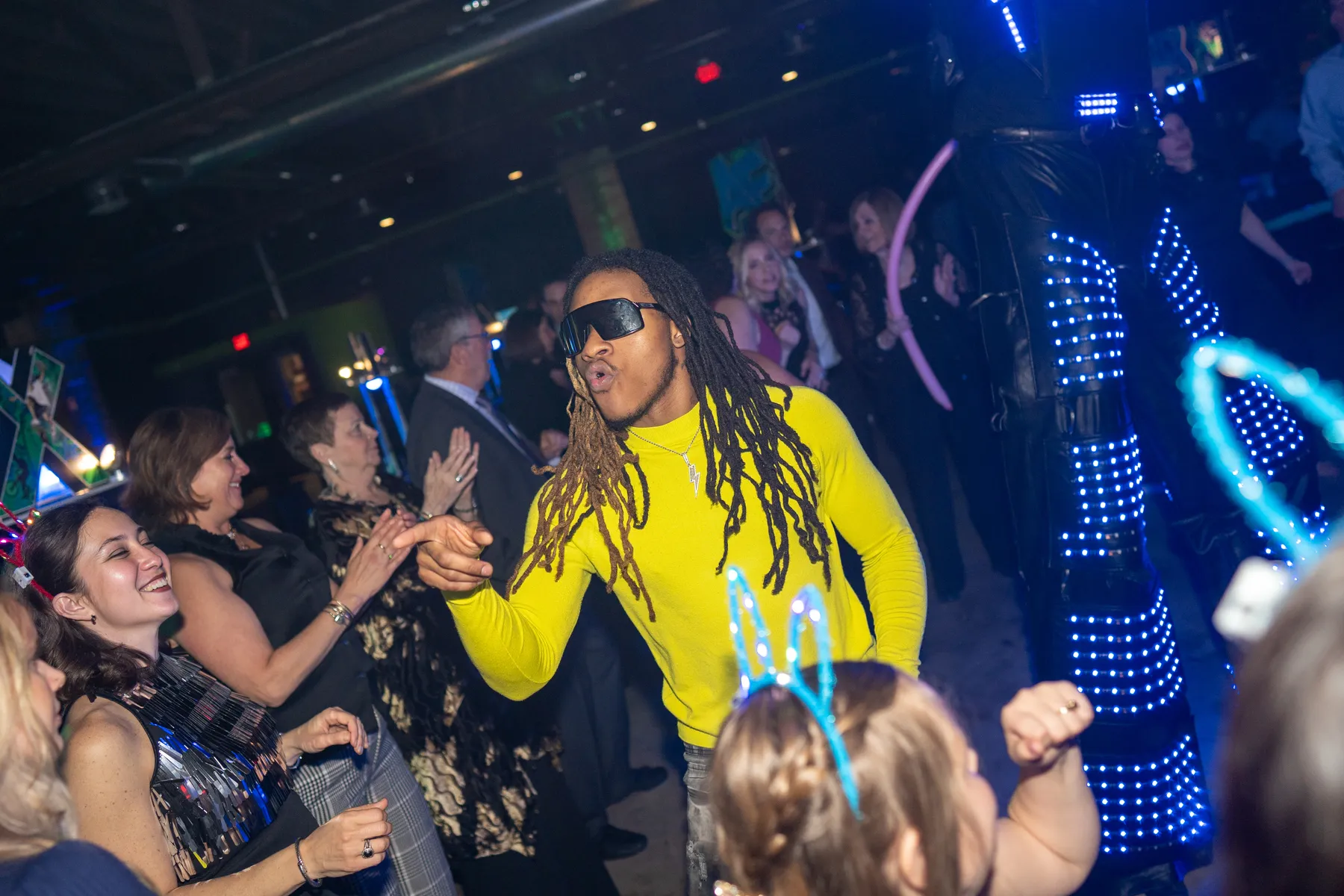 A costumed LED performer entertaining guests at a mitzvah celebration.